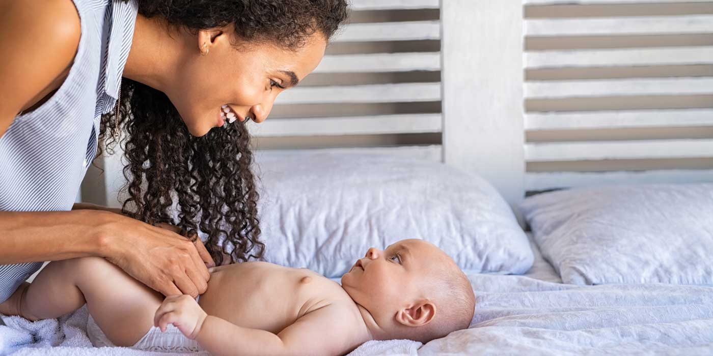 Mother changing baby